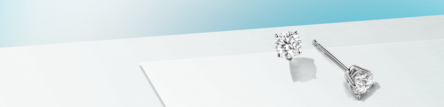 Birks Blue Round Solitaire earring on a baby blue and light blue background